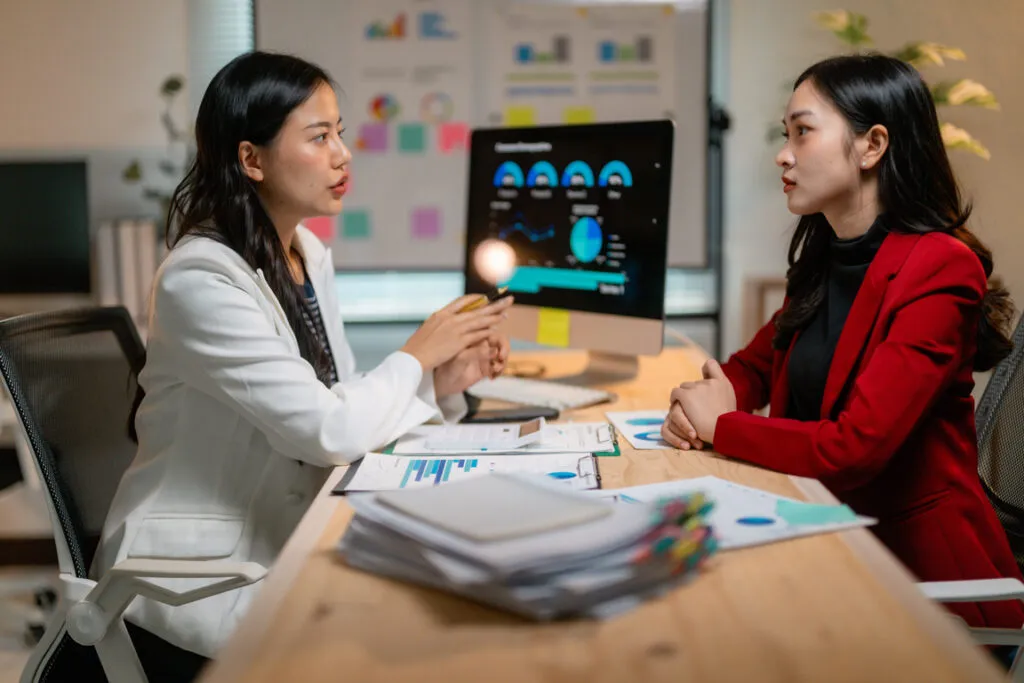 Businesswomen discussing a strategy at a computer