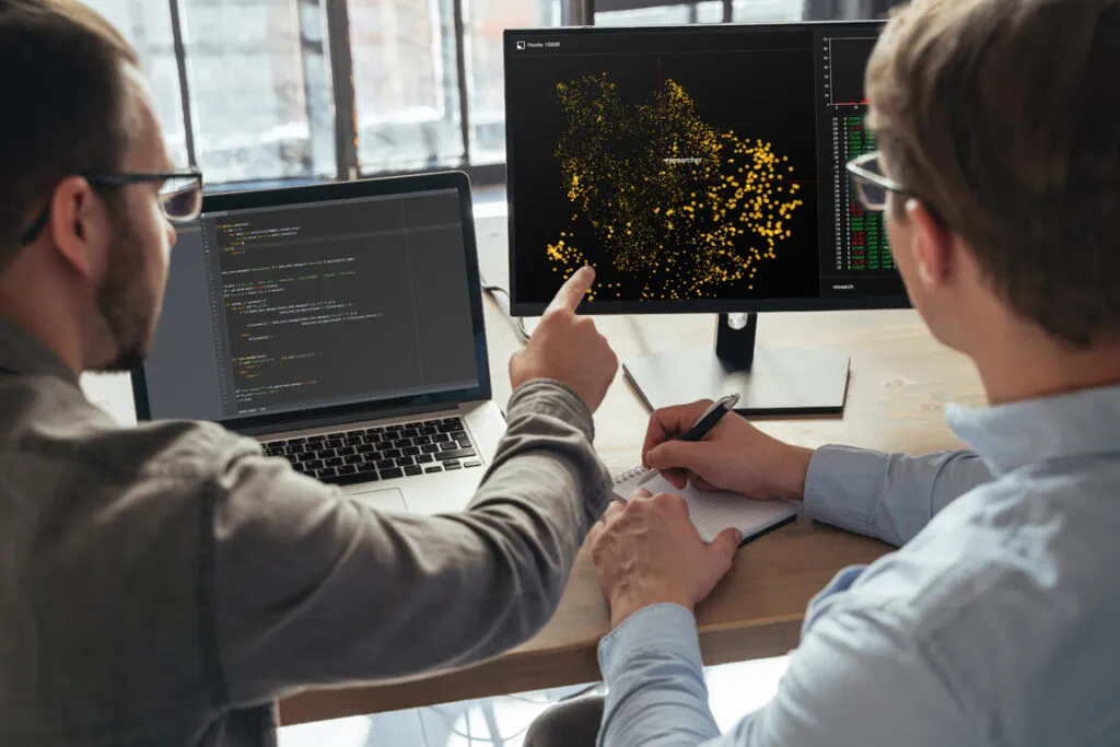 Data science specialists analyzing dashboards together